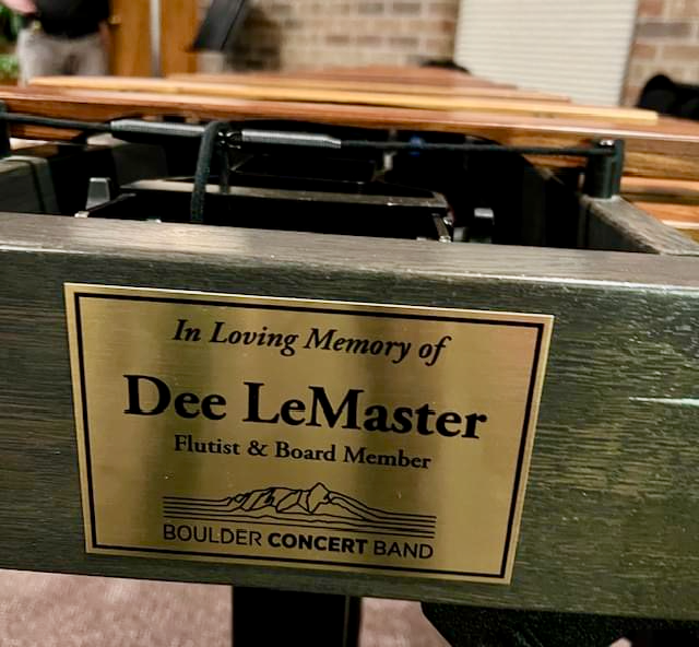 plaque affixed to end of marimba reads 'In Loving Memory of Dee LeMaster flutist and Board Member Boulder Concert Band'