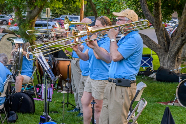 four trombone players, standing