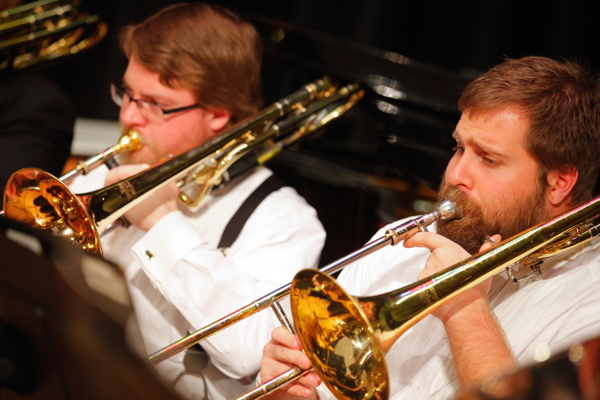 two men playing trombones
