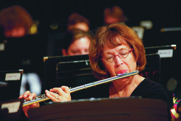 woman dressed in black, playing flute