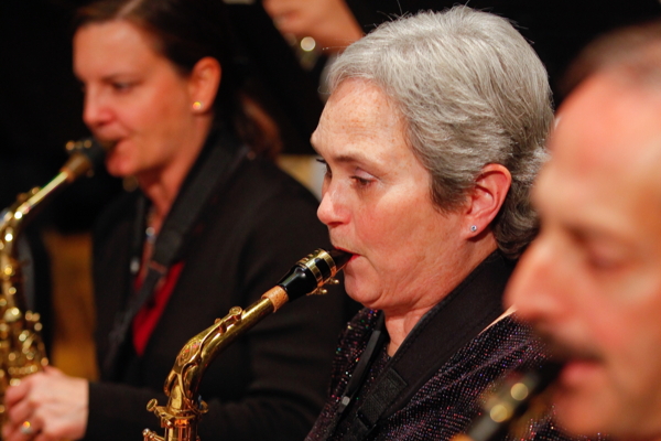 two women and one man playing saxophones