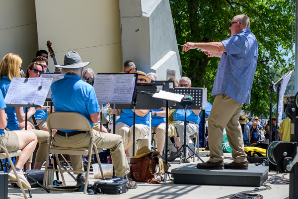 man in blue shirt conducting band