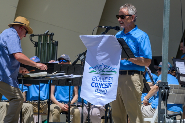 man in blue shirt announcing for the band