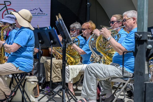 players seated, playing french horns