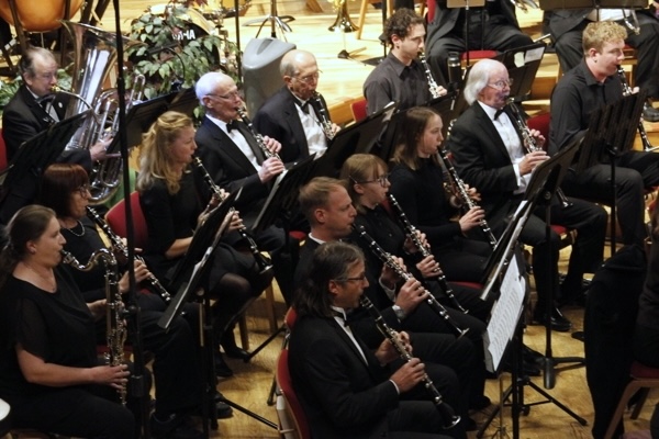 clarinetists dressed in black concert attire and seated in rows