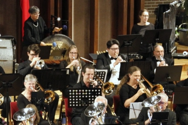 a group of people playing trombones and trumpets