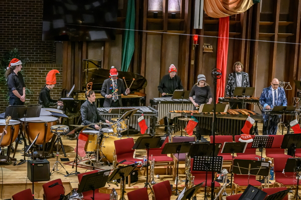 people playing various percussion instruments, wearing festive hats