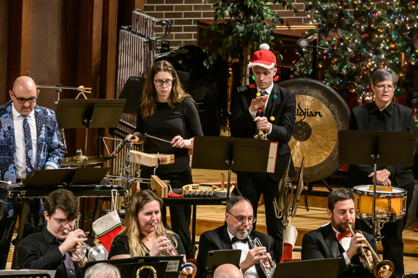 percussionsts standing behind trumpet players