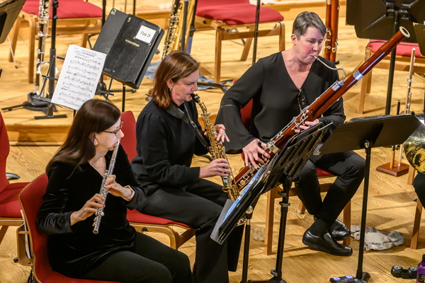 three women playing a flute, a soprano saxophone and a bassoon