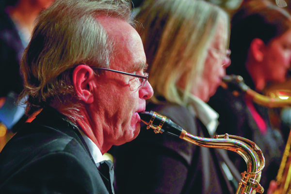 a man and a woman playing tenor saxophones